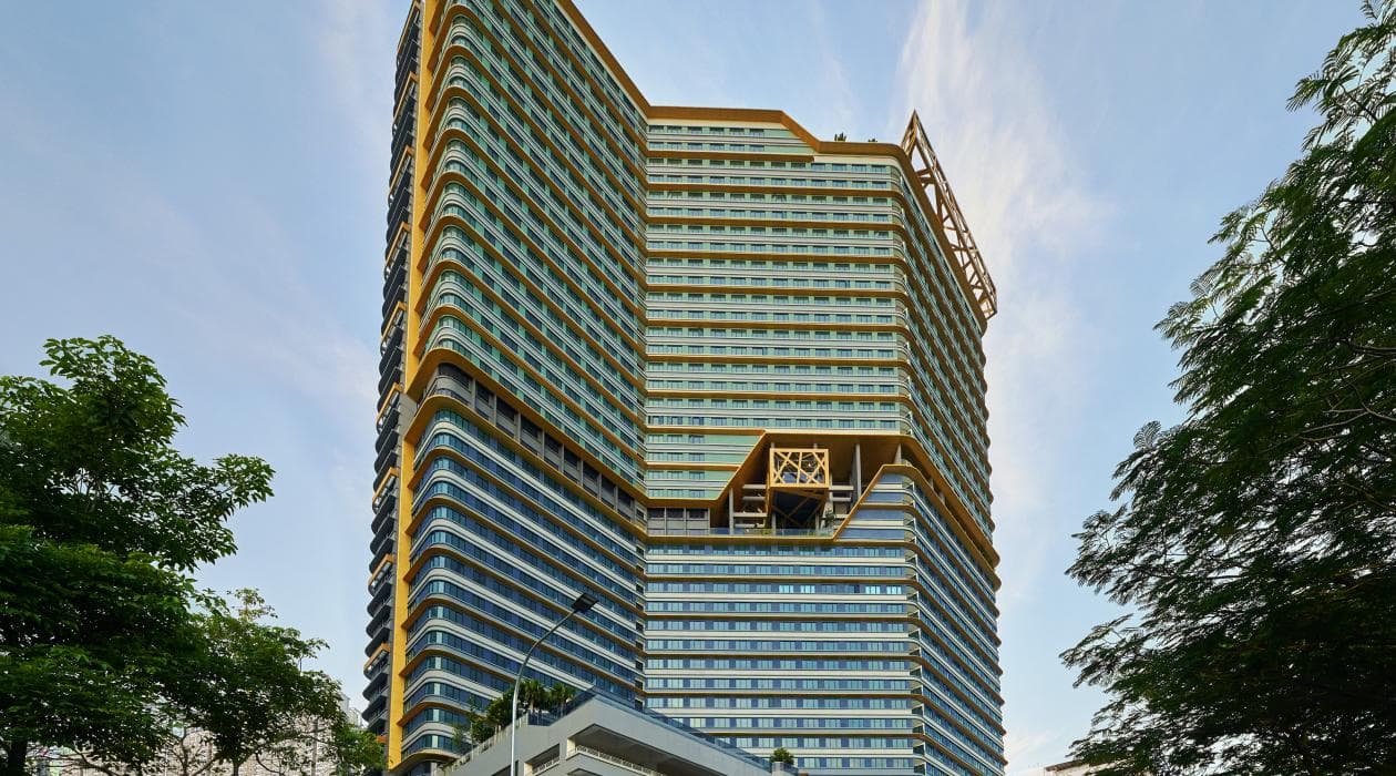 High-rise residential development framed by trees.